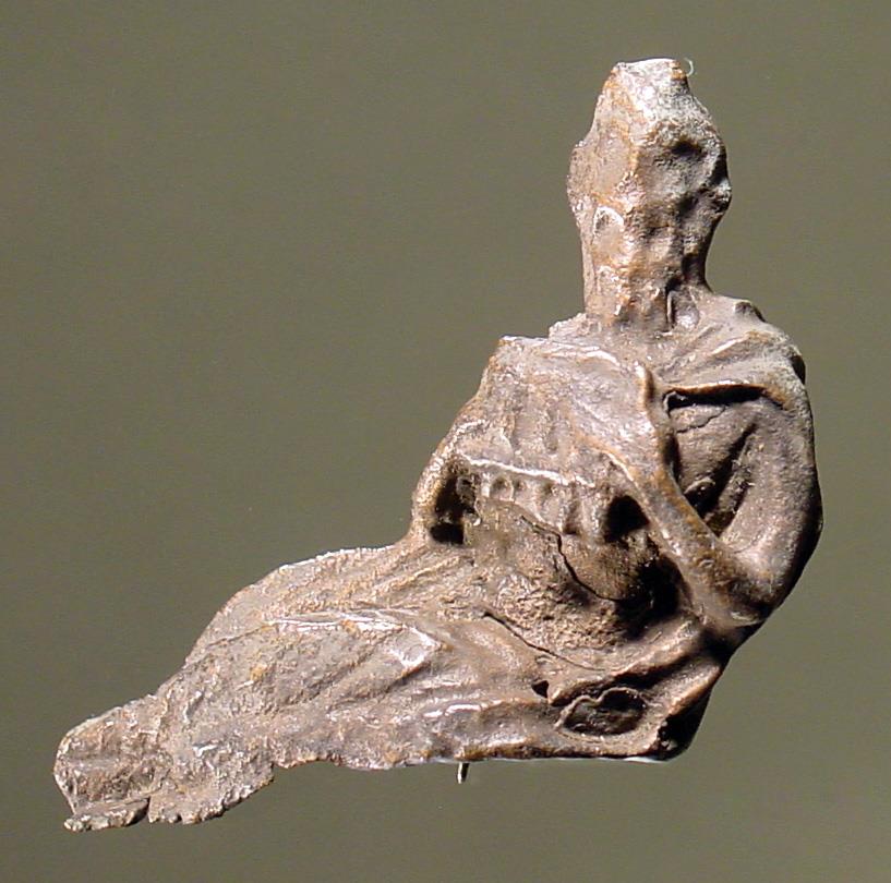 Statuette eines sitzenden Pan; mit beiden Händen hält er die Syrinx; um die Schultern hat er ein Fell oder ein Gewand geknüpft