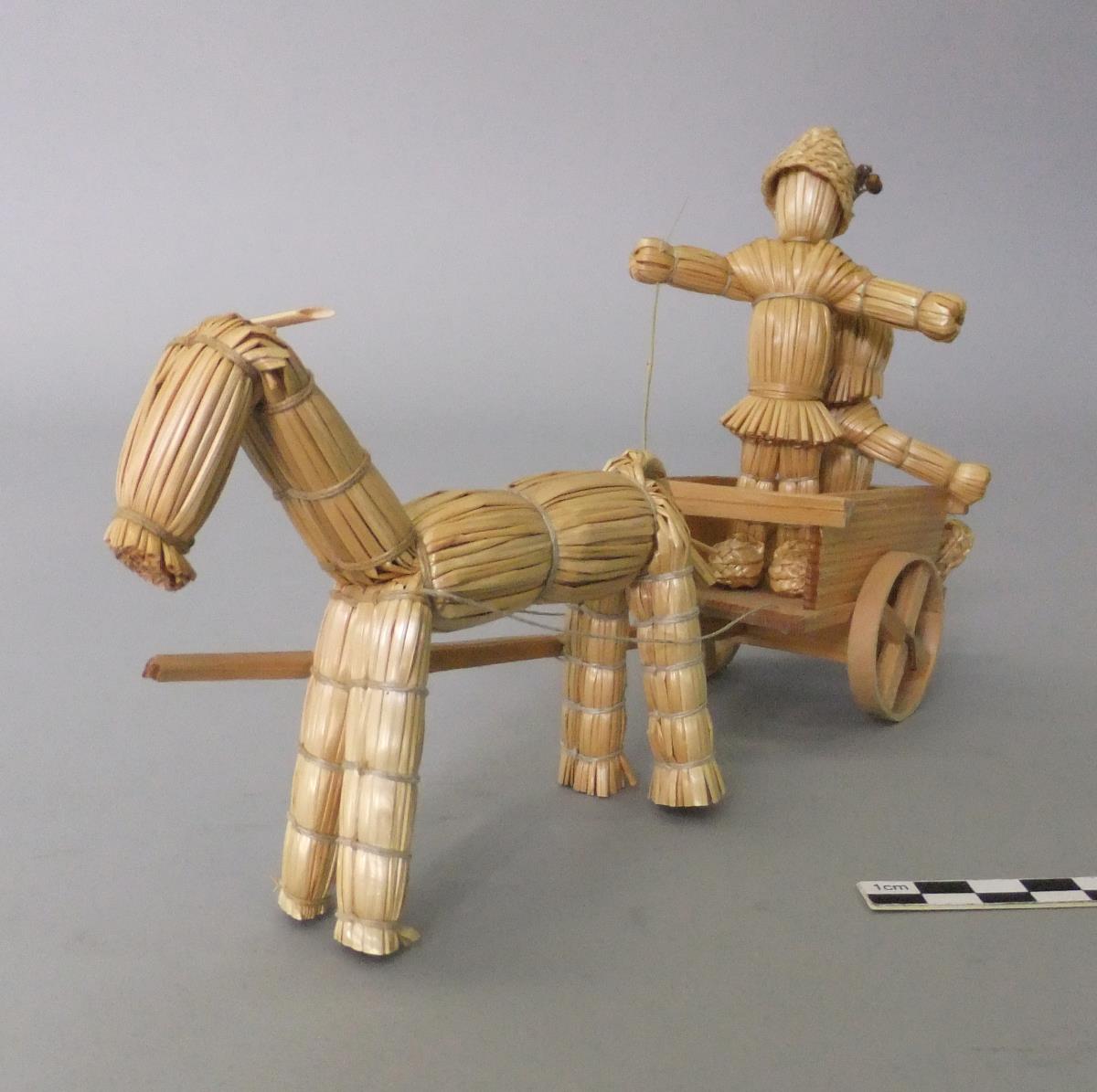 Pferd mit Karren, darauf Junge und Mädchen