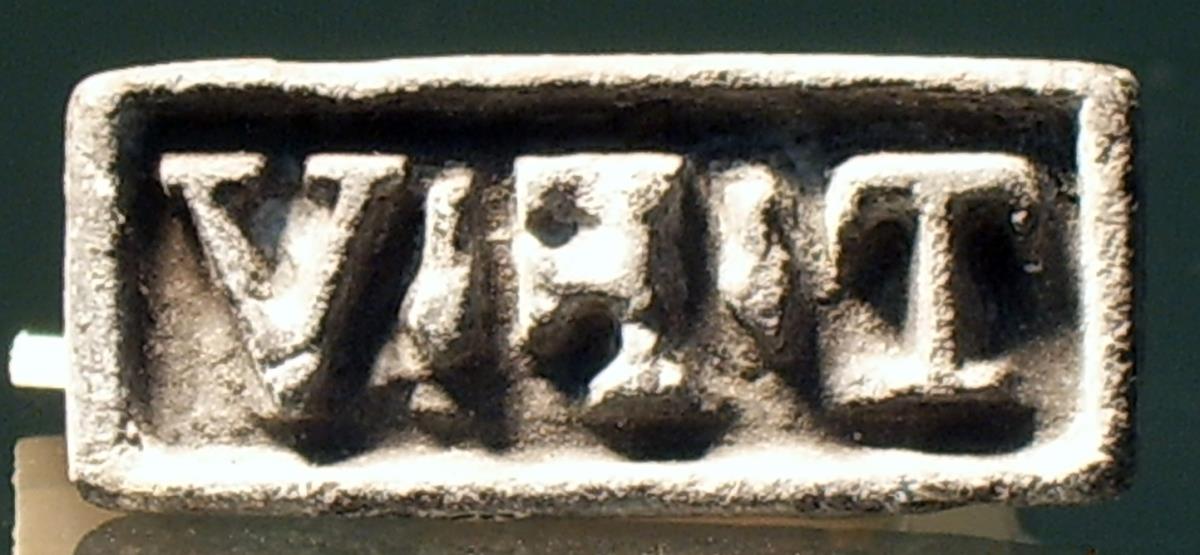 Rechteckiger Stempel mit lateinischer Inschrift: T . F . V