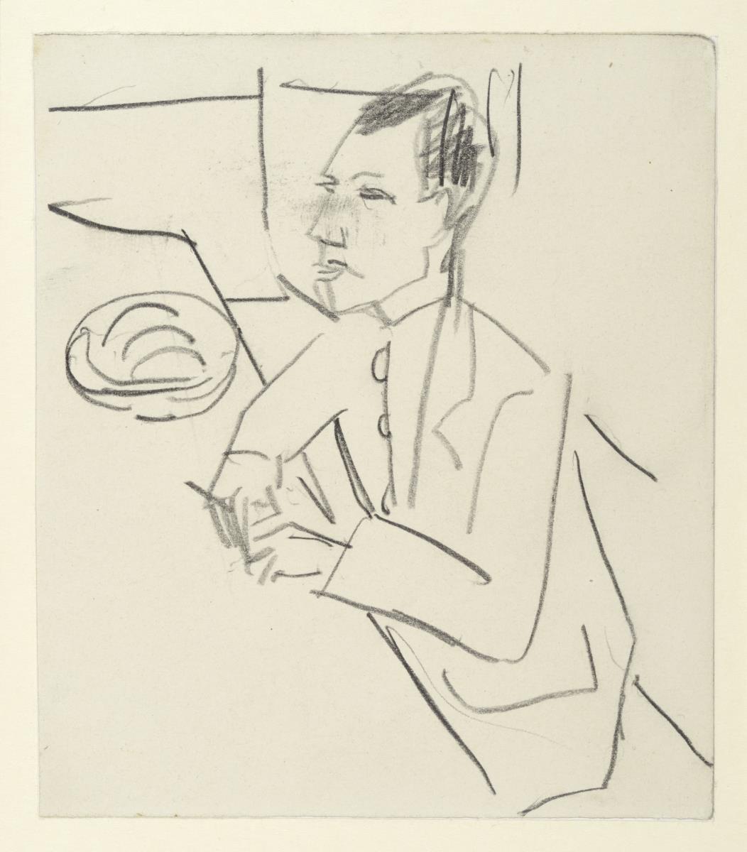 Hans Gewecke, an einem Tisch sitzend