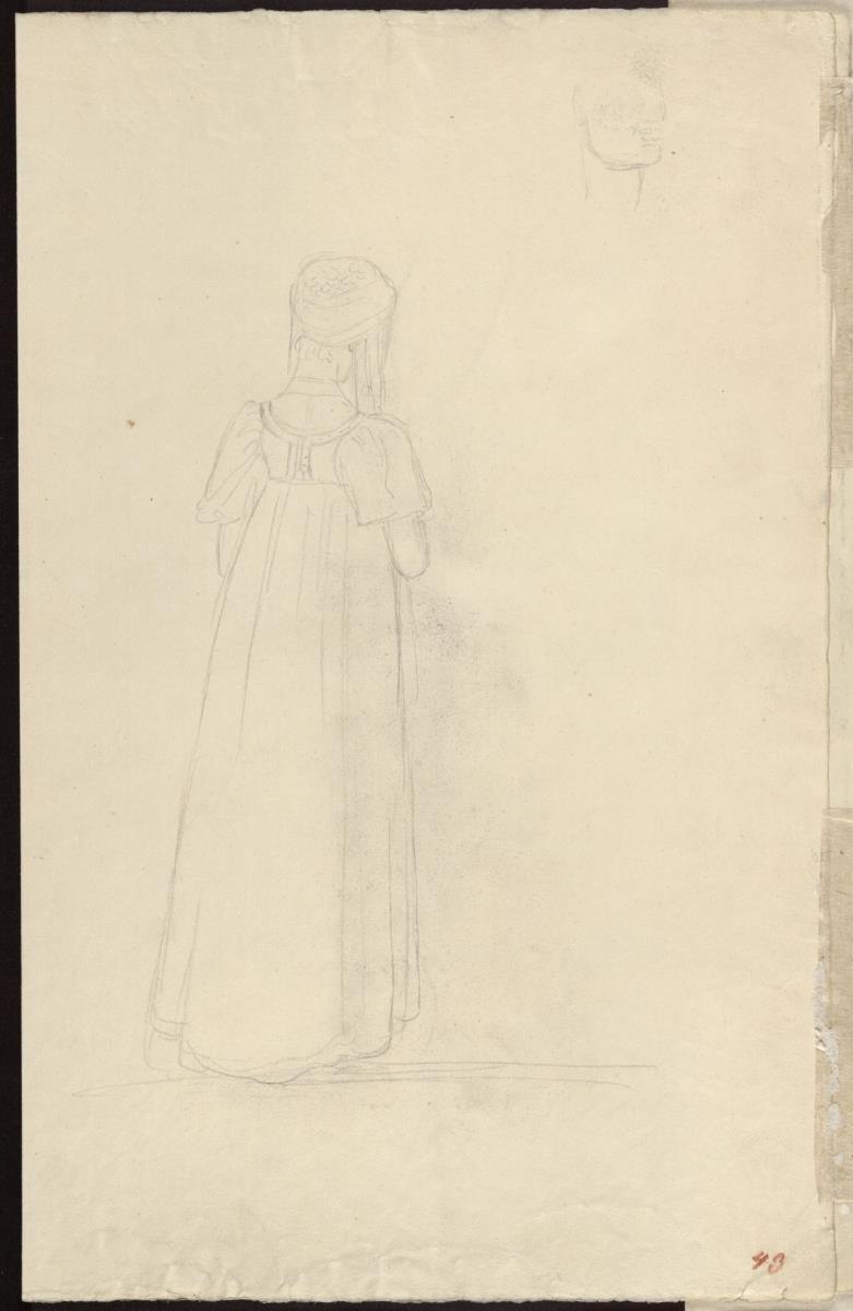 Rückenansicht einer Frau mit turbanartigem Kopftuch