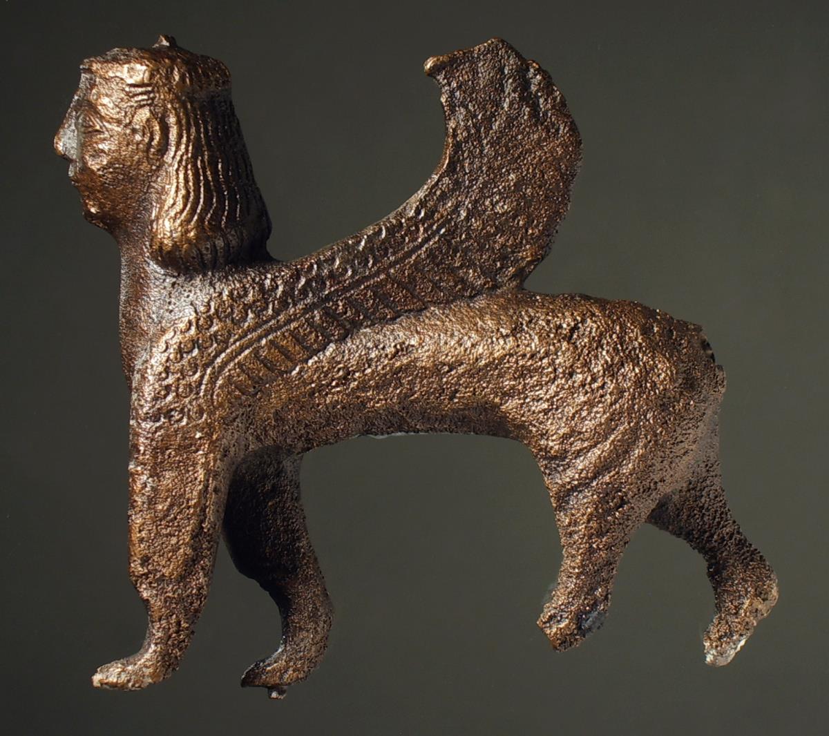 Schreitende geflügelte Sphinx, Oberfläche stark zerstört, verloren: Schwanz und untere Teile der Hinterbeine; im rechten Vorderbein Einlasszapfen erhalten, Flügel laufen zusammen (massiv)