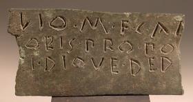 Bruchstück eines Bronzestreifens mit dreizeiliger Inschrift aus altlateinischen Buchstaben